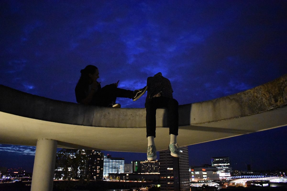 picture of orhidee and his friend on sixteenth floor at night